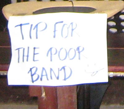 The sign reads 'TIPS FOR THE POOR BAND'...